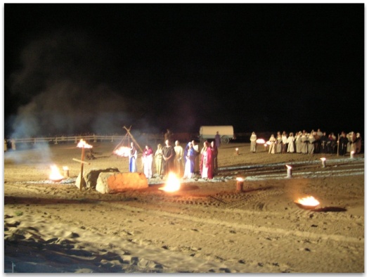 The Nine members of the small boat - surrounded by bonfires, facing the cross at the evocation of Les Saintes Maries de la Mer